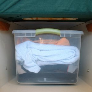 Oak cleats glued with Liquid Nails for shelf to rest on. The cushion is being held in place in this pic just by the tight fit and the sheets.