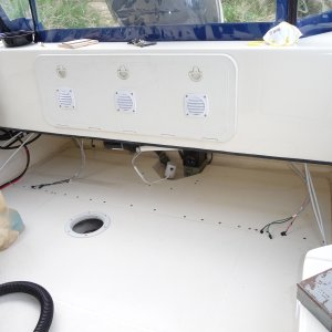 2. I used a 3/8" drill bit to drill through the top of the cockpit deck fiberglass down through the dark grey foam core to touch the bottom layer of the laminated deck. I then took a "Dremel" and hollowed out a greater amount of foam core below the top deck layer of fiberglass to give a greater area to fill in with epoxy.