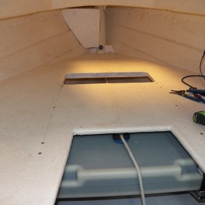 This shows my ground tackle system from the inside.  The anchor line goes through the cam cleat under the V berth to a thru-deck pulley, up through the hawse pipe, through another thru-deck pulley, and to the anchor.  The anchor can be raised and lowered from the helm.  The system is rated at one monkey power.