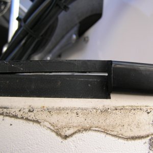 I can now more easily address this.  The transom cap coming unglued.  Plan is some black 4200 and clamps.
