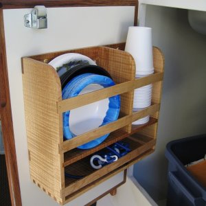 Left-hand cabinet door storage compartment.