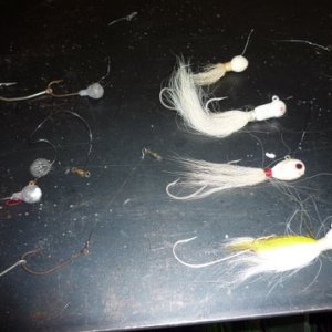 new bucktails with trailer hooks on right, lefthand side is what they look like after the toothy bluefish do to them in a couple days worth of fishing