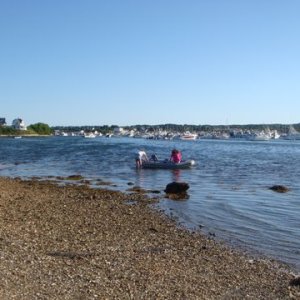 pushing off from Dingy beach on the salt pond of Block Island to try and find their anchored boat. Our boats are out in front of the first house down on the left