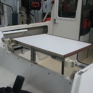 Media 'Cabin table hangs over tubing via stock wall tabs. The rod holders act as side stops. No modification needed.' in album 'Made from two 10 1/2" SS mixing bowls.  Flea market, $4.00/each.'