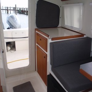 Media 'Lg storage cabinet w/drawer, side roller curtain, aft velcro attached window cover, cushion colors, rolled up cockpit doorway curtain' in album 'Galley - sink, Wallas diesel cooktop/heater w/small black control, Stbd interior window shade, Vessel Sys DC Monitor VSM 422 in front of sink'