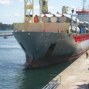 Dutch ocean going freighter carrying wind generators entering lock.