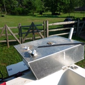 An 2008 Venture 30 gallon aluminum fuel tank. The second rubber strip it sits on laying on top, contact cement drying. No anti siphon valves found on my fuel pickups