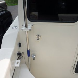 Added a faucet to my fresh water pump and tank.Just t'd off the output side of the fresh water pump. Easy to empty tank now can use for a cockpit shower. But the best is using it to wash down,the anchor chain or the scum line boat and brakes after retriving from salt water and even giving the motor a fast flush.We carry a rollup 50' hose to get water or use it for wash down purposes. Handy spot for our boat hook,gaff, net, scrub brush handle made by Slo lo marine. A short piece of pvc pipe which is 5200'ed to the floor keeps the bottom from moving around. My pliers holder for fishing expeditions is the rectangular block with th oval hole. Also the switch and outlet for my raw water washdown which we have elimanated the thru hull  and have a hose with a screened pickup which we put overboard connected to the pump for the raw water wash downs intake.
