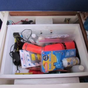 Added a box over top of my water tank which is located under the rear portside dinette seat cushion. Made out of 3/4"marine plywood used wood blocks mounted on either side then ran stainless steel lags into the blocks from both sides it's about 9" deep and does not come into contact with the water tank. Easy access for emergency flares etc about 14" x 14" x9" deep
