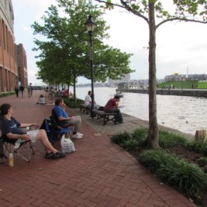 near Inner Harbor Area these people are getting to hear an area concert for free from across the water