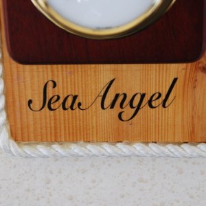 Media 'Vessel name was printed with MS WORD on a 'Clear Shipping Label', 11/2"x41/8", by AVERY. It was set in place and sprayed with a clear acrylic spray that you can get at any art supply or hardware store. The 3/8" line was hot glued to the base's outer edge.' in album 'The WX Station is mounted with a hinged back for easy access to the clock battery & its adjustment.'
