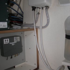 Media 'Aft wall of the under sink cabinet showing the hot water faucet "fix" by just tossing the nylon fitting and clamping directly to the faucet threads after heating the hose.' in album 'Aft wall of the under sink cabinet showing the hot water faucet "fix" by just tossing the nylon fitting and clamping directly to the faucet threads after heating the hose.'