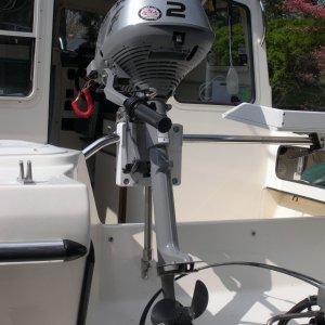 Honda 2 HP outboard in place.  I will attach a 6x6 piece of starboard to the base of the splashwell below the OB skeg with screws to prevent damage.