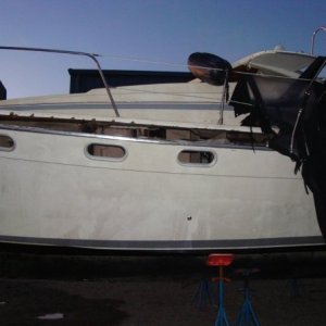 Media 'Port side. Where it came apart at the seams. That's the canvas hanging off to the right.' in album 'This is the lead boat, Captain Impatient. When it hit the rock, it bent the strut and chewed up the prop.'