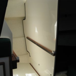 Port leg space for forward-facing seat showing rails for crate storage system.