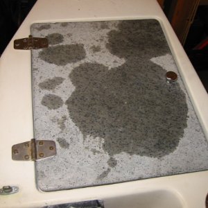 Original cover recessed into molded area -- leaks into lazarette.