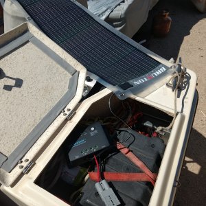 Media 'Someone gave me a 14 watt panel, which is perfect for keeping my batteries topped off (test run going on here). 

Bought a 30 amp controller which I'll mount in the cabin and eventually add a couple panels to the roof rack. We plan on getting a fridge in the near future so solar will be a big help with that.' in album 'Port lazarette: this is where the house battery is going. Drilled a hole for the cables, added a grommet and some anchors for the battery hold down strap.'