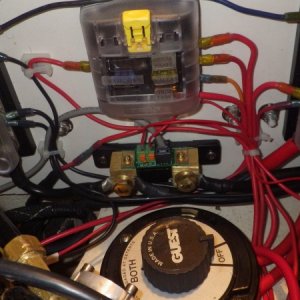 Cleaned up wiring in starboard lazerette.  Battery on left. Autopilot pump on right.  Buss bars and fuse box instead of spaghetti.