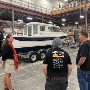 Rosanne and Harvey listening to Michael talk about boat building