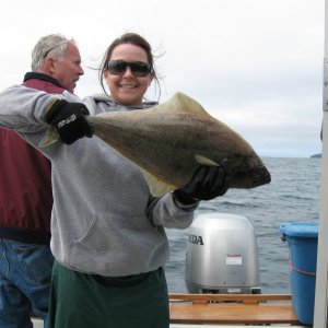 Sara and the first halibut on the boat.