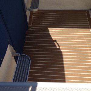 Plasdeck faux teak flooring. The color scheme was "Holly w/ white lines".