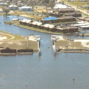 Media 'Arial view Clewison Lock- entrance to Roland Martin Marina and U.S. Army Corp of Engineers office:  This is a "pass thru lock" most of the time, exception, it is closed due to a huricane.  Route 2 or the Rim Canal continue to Port Mayaca from here.  This is the start/end of Route 1 across The Big "O" to Port Mayaca.' in album 'W.P Franklin Lock: Lock chamber:56'x400'- Vertical lift:Sea level to Caloosahatchee River, 2' to 3'- Discharge capacity 28,900 cfs(cubic feet per second)Operates daily 6:00A to 9:30P-Marine VHF radio Channel 13-Located at Okeechobee Waterway 
statute mile 121.4  NOTE: The Okeechobee Waterway ends/starts at Day Beacon #101, in San Carlos Bay.'