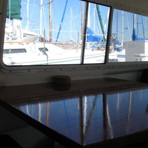 Larger table, mahogany, ten coats varnish, scribed to contours of boat