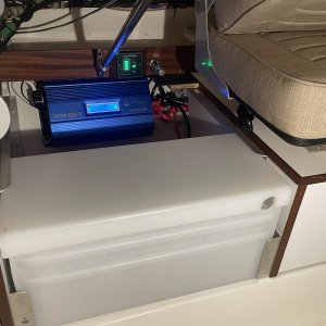 the large group D battery fit perfectly between the two storage areas.  The angle aluminum at the top edge holds it down firmly and the movable angle brackets allow the lateral movement