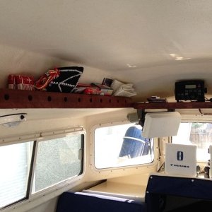 Media 'New ceiling shelf, port side.  Holes drilled for viewing of what's on shelf.  The holes added an unexpected nautical look!' in album 'Finished utility/spice rack behind galley'