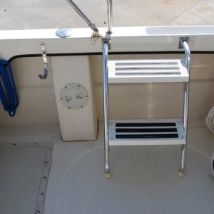 Port side mounted portable cockpit step ladder forward of fuel fill system access port.