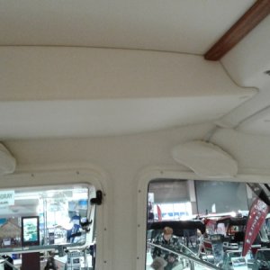Vinyl Interior glue is supposed to be better than earlier models. Sleeping area uses hull blanket (Carpet).  
Shelf above helm is enclosed which adds nice faceplate for small electronics but it also may reduce storage of previous open shelf layout. Added center wiper.
