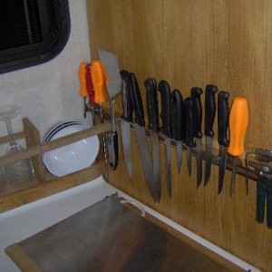 Magnetic bar holds lots of knives and tools