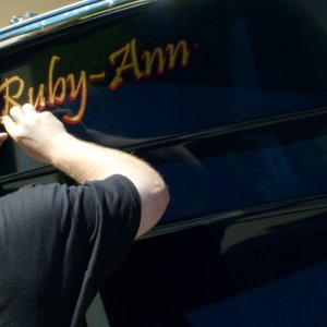 Merzlak Signs applying lettering