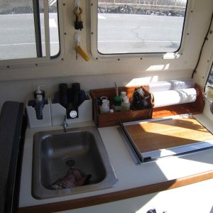Built Galley Storage Out of African Mahogany and finished with Spar Varnish. Pooped out on building the rest of it and just bought some plastic stuff from West Marine.  Works well, just doesn't look as good.