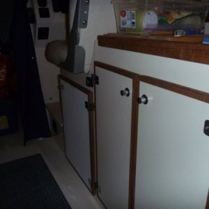 new door under helm seat for heater.Heater control just under the rear of the helm seat almost hidden behind the hinge for sink cabinet