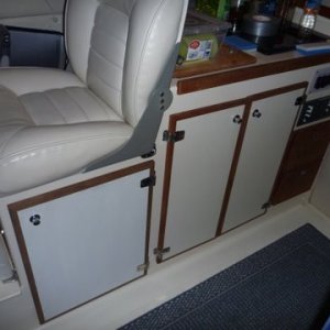 Media 'NEED TO GET A BETTER COLOR MATCH WITH THE PAINT' in album 'Basic mounting under the helm seat where refridgerator was removed. Fresh air intake under right side of seat box just beyond the heater on the left from this view. Heat exhaust under foot box in the helm seat area. Mount made out of 1/4 inch aluminum and 3x4 aluminum angle bolted to front of helm seat box. The four bolts up top are the existing four bolts for the helm seat. I used them for securing the extra long wires from my outboard motor controls and on off switch, bolted fuse holders etc, the heater sits right under the helm seat. What's different also is the hot air exhaust has been changed to 3" instead of the normal two inch, as I will add a Y pipe for a second duct if need be. From what I noticed so far a second duct won't be needed. This heater puts out better than an ugly girl on prom night.'