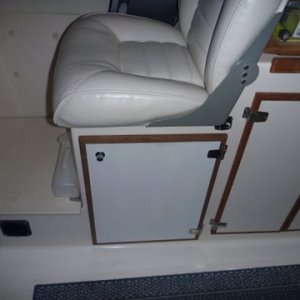 Media 'DOOR WILL OPEN ALMOST 180 DEGREES' in album 'Basic mounting under the helm seat where refridgerator was removed. Fresh air intake under right side of seat box just beyond the heater on the left from this view. Heat exhaust under foot box in the helm seat area. Mount made out of 1/4 inch aluminum and 3x4 aluminum angle bolted to front of helm seat box. The four bolts up top are the existing four bolts for the helm seat. I used them for securing the extra long wires from my outboard motor controls and on off switch, bolted fuse holders etc, the heater sits right under the helm seat. What's different also is the hot air exhaust has been changed to 3" instead of the normal two inch, as I will add a Y pipe for a second duct if need be. From what I noticed so far a second duct won't be needed. This heater puts out better than an ugly girl on prom night.'
