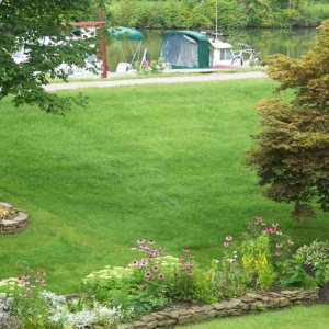 Beautiful lawn and gardens at the Adams Basin B&B with a couple of C-Dories at their dock.