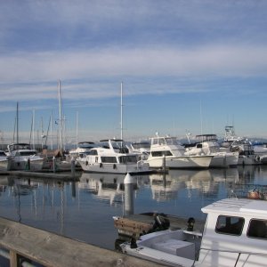 Media 'Just boats with a partially clear sky.' in album 'First Visitor'