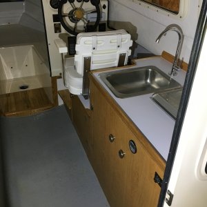 Installed faucet connected to forward water tank and water pump. Also ran the water hose to the stern for a washdown hose.