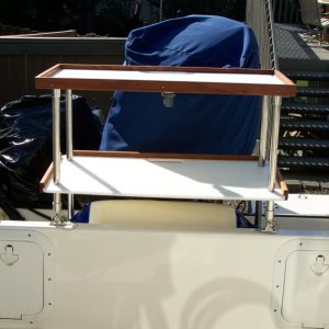 Media 'Unit can be reversed (with 9 inch leg extensions added) to mount inside cockpit to allow raising of motor and installation of camper canvas' in album 'CD25 cockpit table and storage shelf. Shelves are made from 16x32 nylon game boards available at Cabelas.'