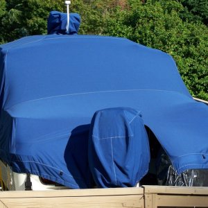 Media 'Great fit. No puddling of rain/snow. Wind can not get under cover. Outboard motor cover is seperate piece.' in album 'CD25 cockpit table and storage shelf. Shelves are made from 16x32 nylon game boards available at Cabelas.'