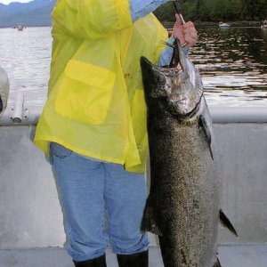 Media 'My sister with a fish.  (Trick photo: she's only 3 feet tall).' in album 'How to get a big halibut into a little boat.'