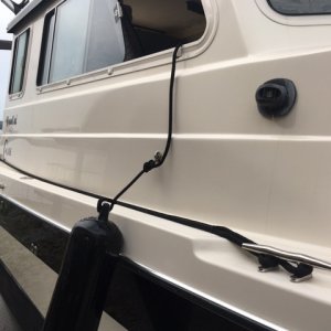 I use a sailboat line lock/cam to secure docking line while underway