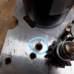 the circled hole is stripped and was the original location of the locking gear. this windlass has an extra hole already tapped for when the primary locking gear bolts strips the threads on the aluminum.  I fixed this with help from the manufacturer over the phone.  Jennie at Powerwinch was very helpful and talked me through the entire repair over the phone