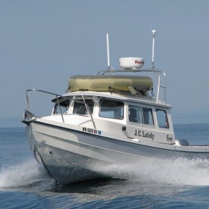 Media 'JC Lately crossing our wake, Whidbey Island in the background, on a glass flat day on Juan de Fuca.' in album '"Enforcement" came in with the Indian canoes.  It's a support boat traveling with the "Tribal Journey -07"'