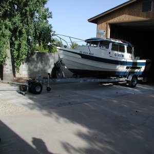 12 volt trailer mover in action.  After entering RV garage, need to make sharp turn to right so motorhome can also fit.