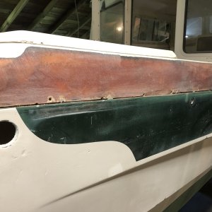 Media 'Because the section of the boat above the rubrail had many areas of spider cracking, I just removed all the gelcoat from that part of the boat. In some spots the spider cracking continued into the fiberglass so I removed that as well, and then put new fiberglass over the entire area. I used polyester laminating resin to do all gelcoat repair, which required painting with gelcoat so it would cure. Then sanding off the gelcoat so a final layer of Totalboat epoxy fairing can be applied and sanded down smooth in prepartion for the Alexseal primer coat.' in album 'Rub rail removal'