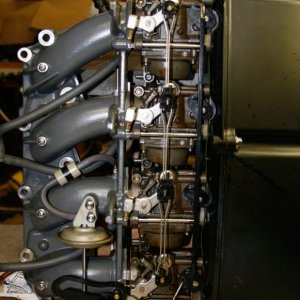 Intake manifold carbs Silencer Assy. You must remove this entire assembly to disassemble the carbs. It is easy to take out the nine bolts holding the intake to the head.