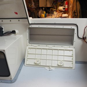 The cables and wires are now in a flexible tube that runs above the hatch, leaving enough storage room for fishing poles and a boat hook.  The hatches lock, so it is the only secure area on a CD16.